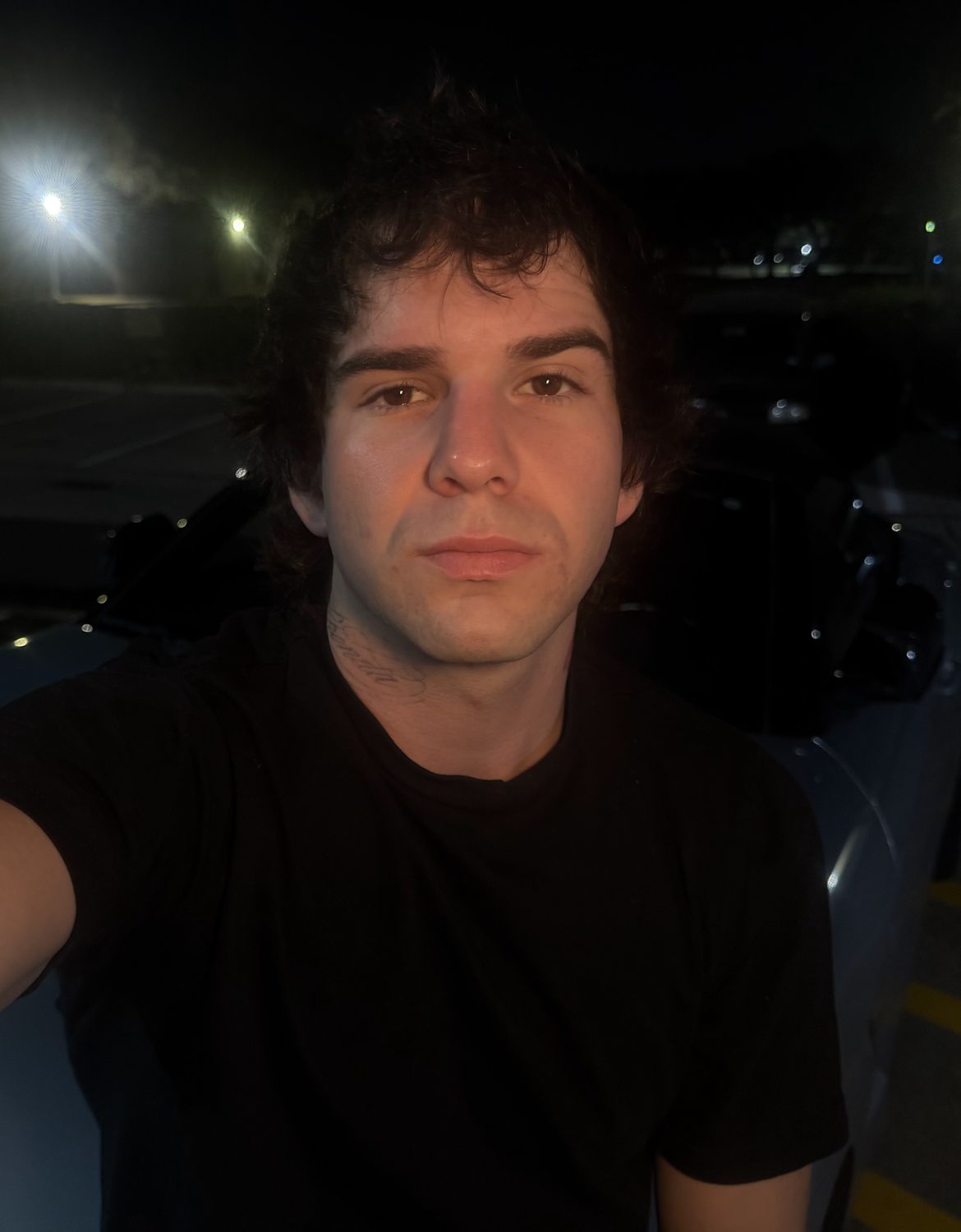 Myles at night in a parking lot
